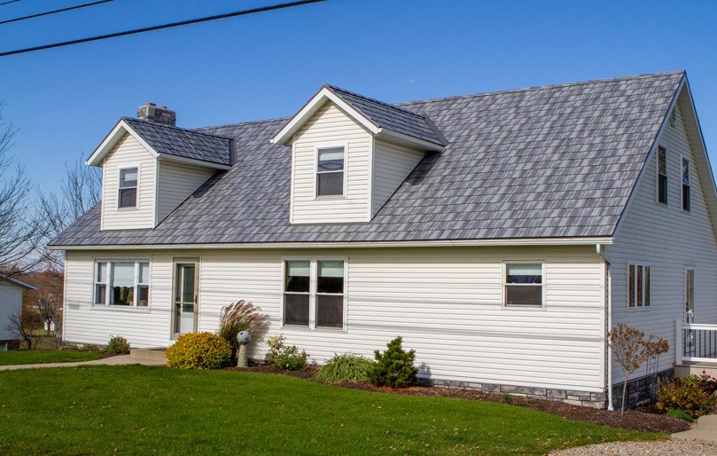 Metal shingles roof on white house
