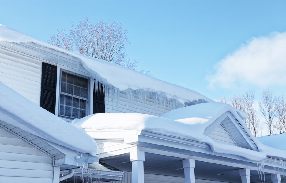 heavy snowfall on house in winter