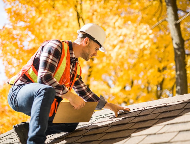 Greenwood residential roof inspector examining roof damage
